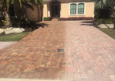 Before and after image of a cleaned paver driveway