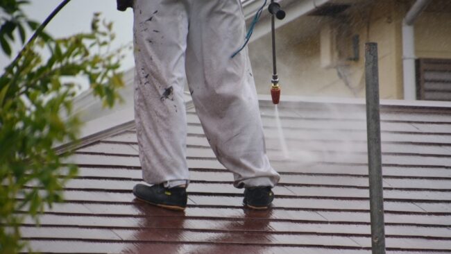 man-pressure-washing-roof.